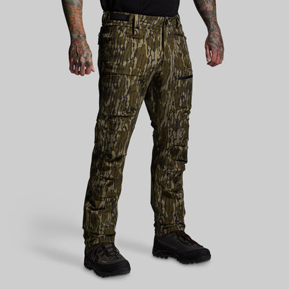 Camouflage pants worn by a person on a gray background