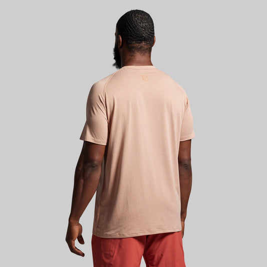 Person wearing a beige t-shirt and red pants against a gray background