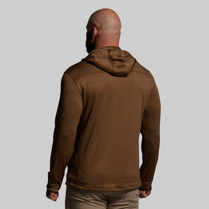 Man wearing a brown hoodie from behind on a gray background