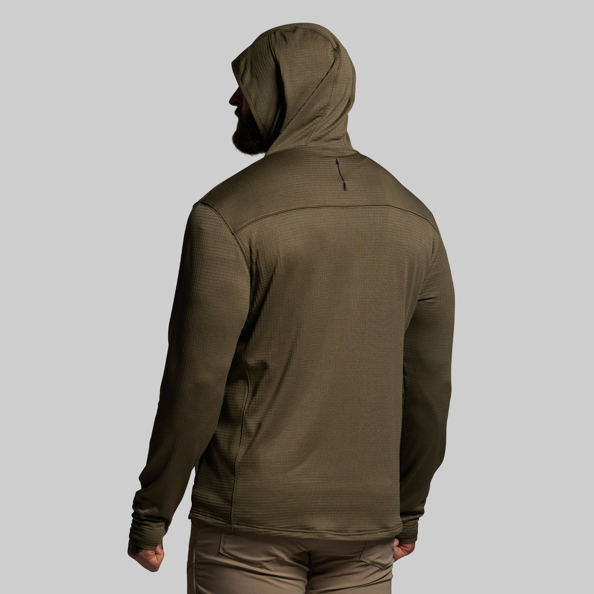 Person wearing a green hoodie on a gray background