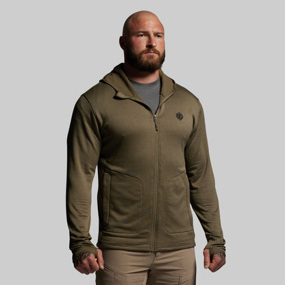 Man wearing a green full zip hoodie with a logo on a gray background