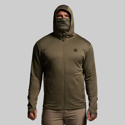 Person wearing a green hooded full zip mid layer on a gray background