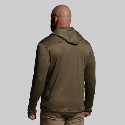 Person wearing a green hoodie on a plain background