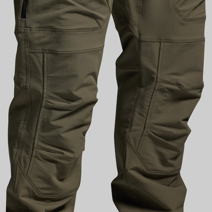 Close-up of olive green outdoor pants on a light gray background