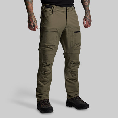 Olive green tactical pants worn by a person on a gray background