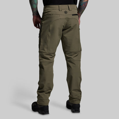 Olive green pants worn by a person on a light gray background