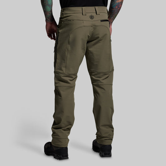 Olive green pants worn by a person on a light gray background