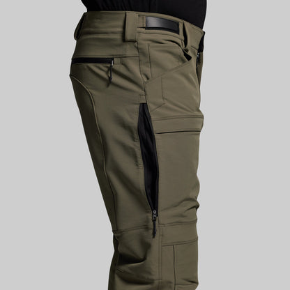 Olive green outdoor pants with multiple pockets on a gray background