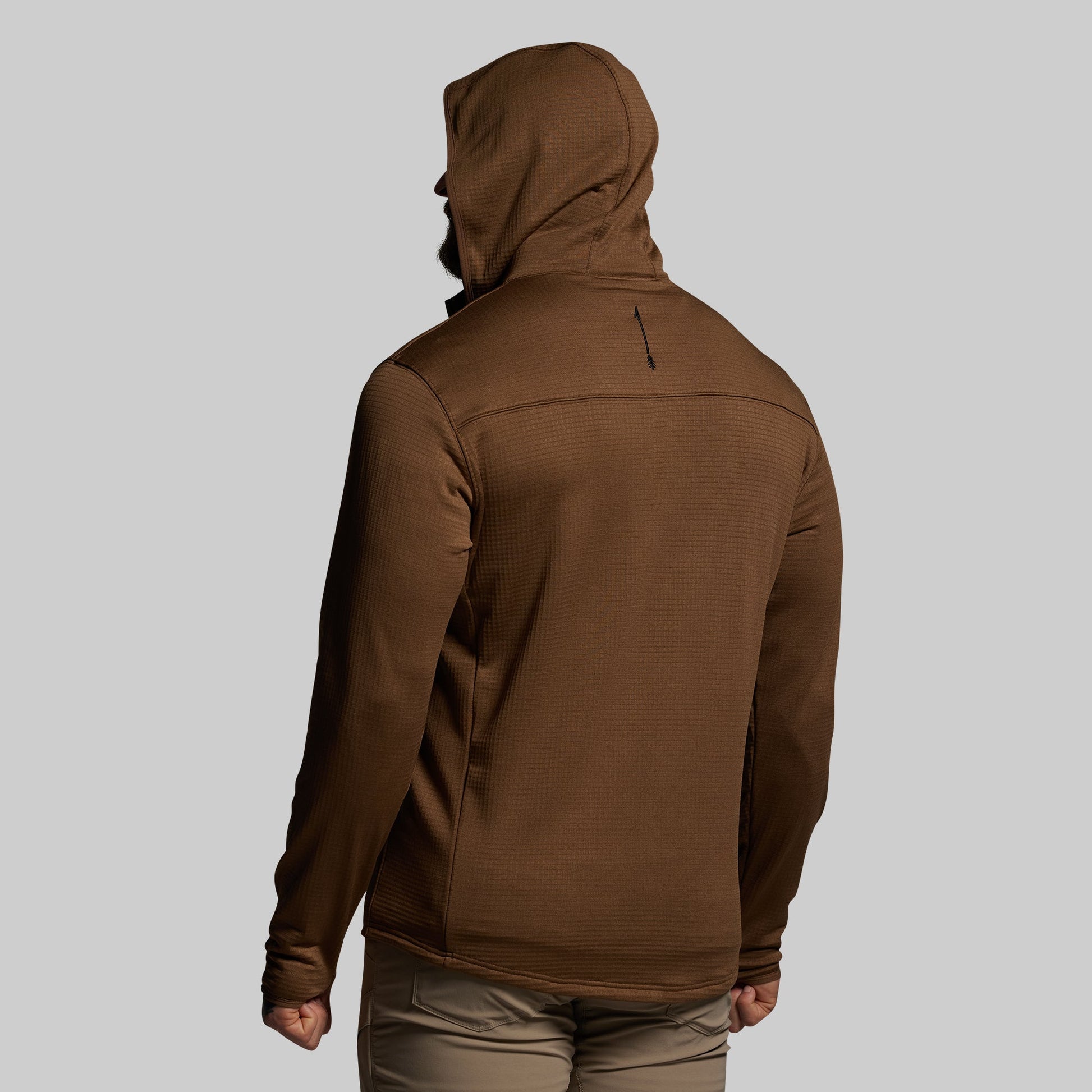 Brown hoodie worn by a person on a light gray background