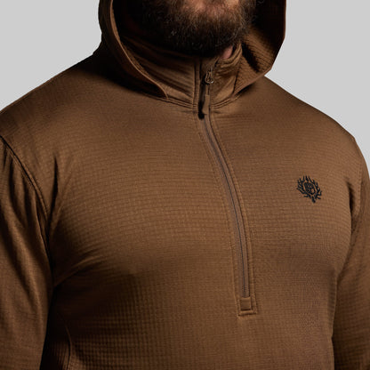 Brown hoodie with a small logo on a gray background