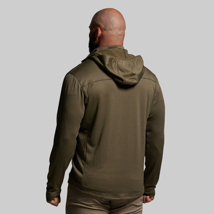 Person wearing a green hoodie on a gray background