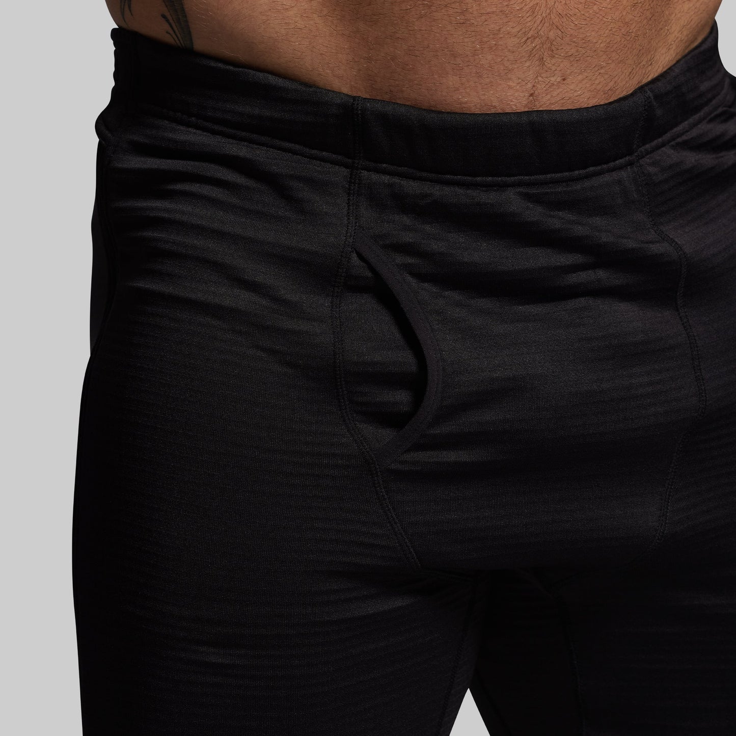 Black base layer pants on a plain background