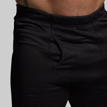 Black base layer pants on a plain background