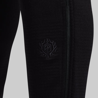 Black pants with a logo against a light gray background