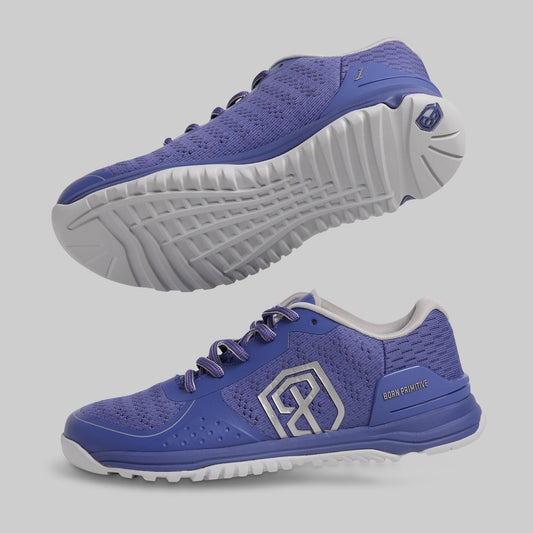 Blue athletic shoes with white soles on a gray background
