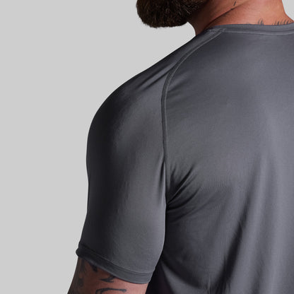Gray athletic shirt worn by a person on a gray background
