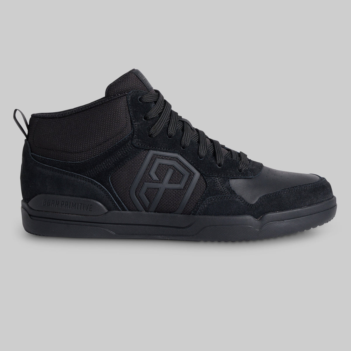 A black mid-top sneaker with a textured mesh and suede upper, featuring a large geometric logo on the side and a pull tab on the heel, shown against a solid gray background.