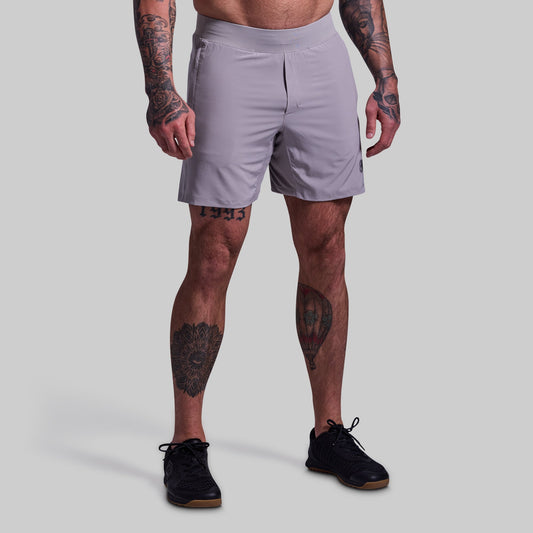 Person wearing light gray athletic shorts on a plain background