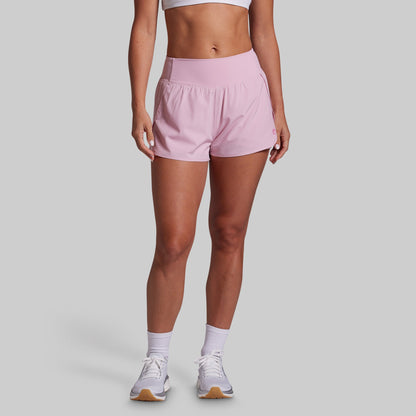 Person wearing pink shorts on a plain background