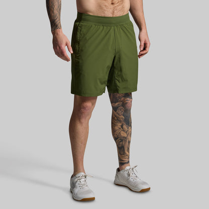 Person wearing green shorts on a gray background