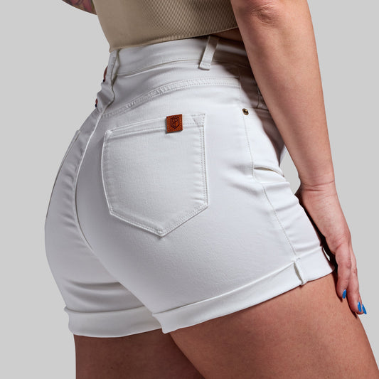 White denim shorts with a brand logo on a plain background