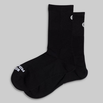 Black socks with white branding on a light gray background