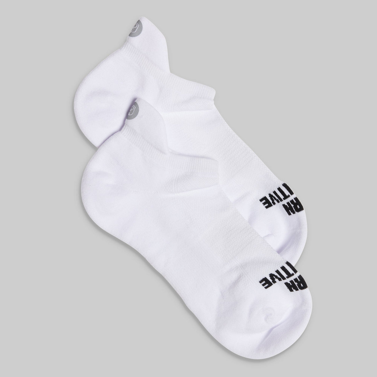 White ankle sock with black text on a gray background