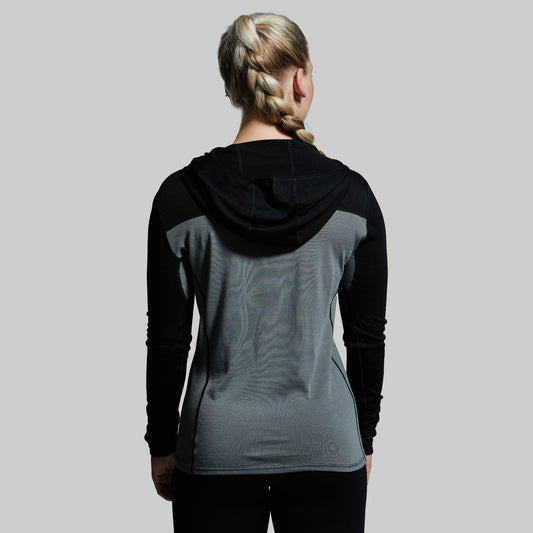 Back view of a woman wearing a black and gray Ridgeline Half Zip Hoodie.