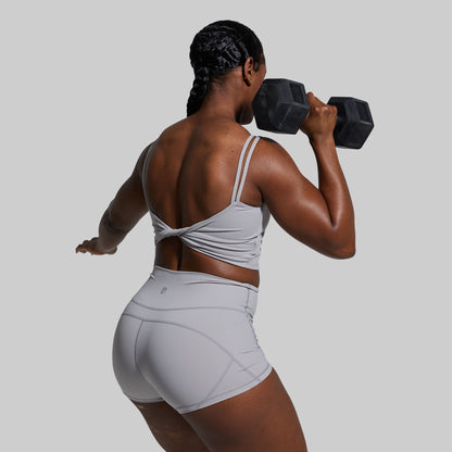 Person lifting a dumbbell on a plain background