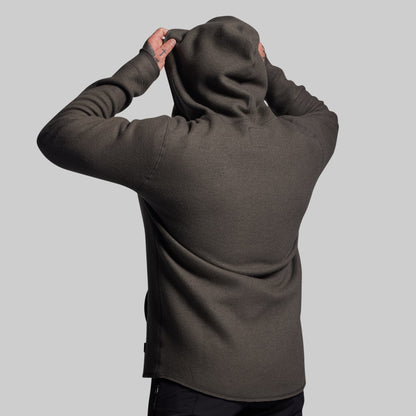 Person wearing a dark gray hoodie from behind on a light gray background