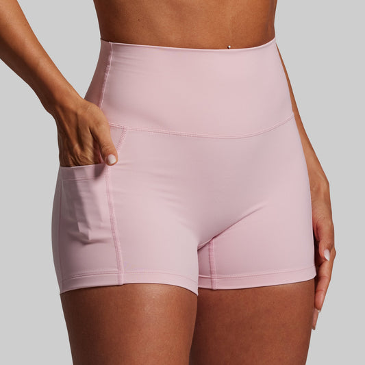 Pink athletic shorts worn by a person on a plain background