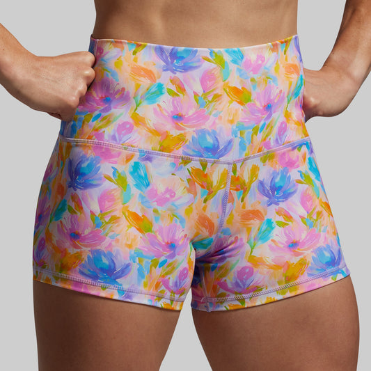 Colorful floral shorts worn by a person on a plain background