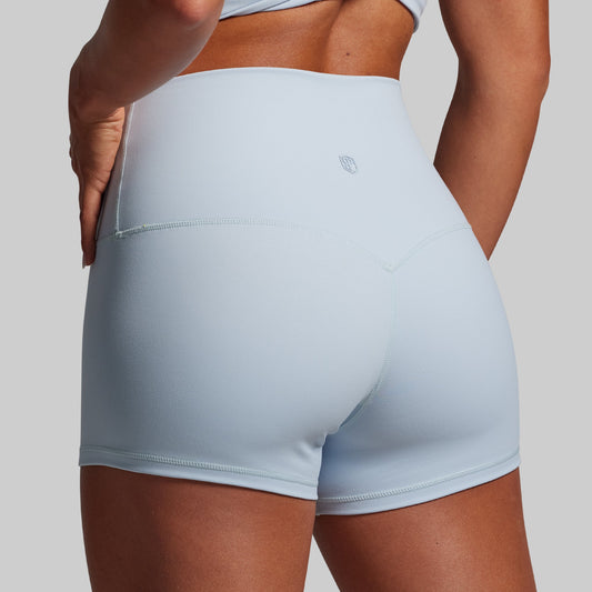 Light blue athletic shorts worn by a person on a plain background