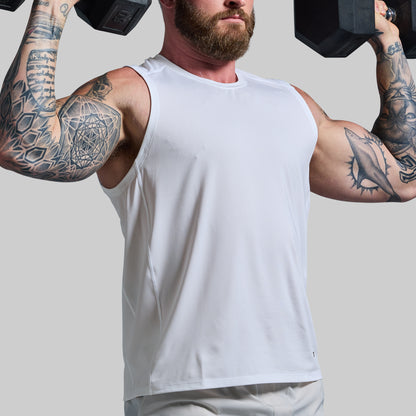 Man with tattoos lifting dumbbells wearing a white tank top on a plain background
