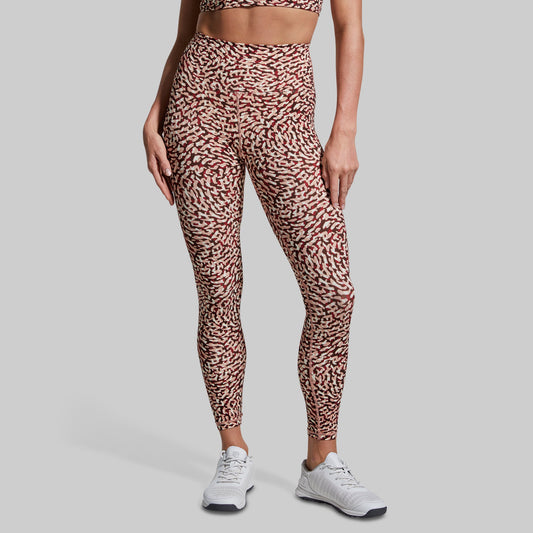 Person wearing leopard print leggings on a gray background