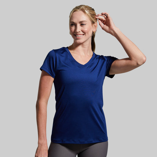 Woman wearing a blue t-shirt against a gray background